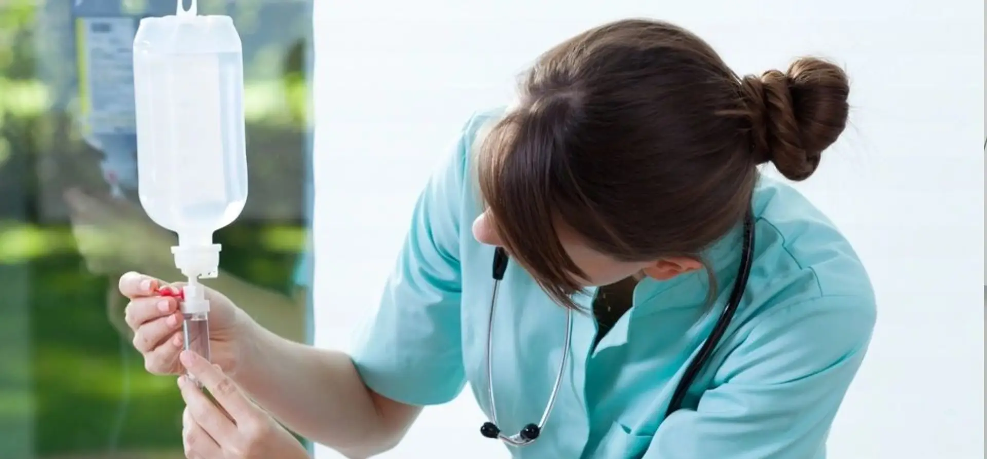 Nurse examining a patient's arm with care and attention.